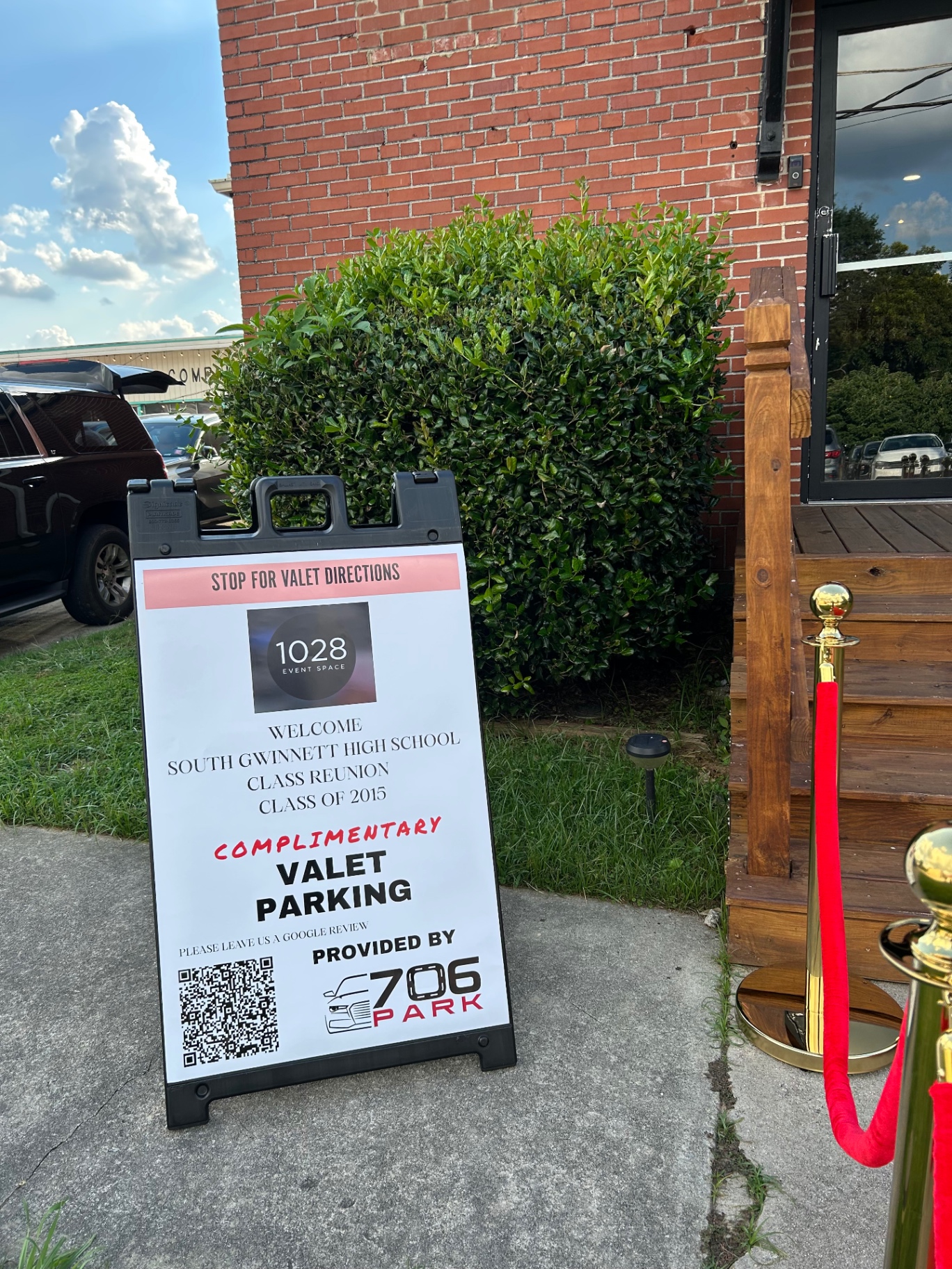 706 Parking Management complimentary valet parking sign with a QR code outside 1028 Event Space
